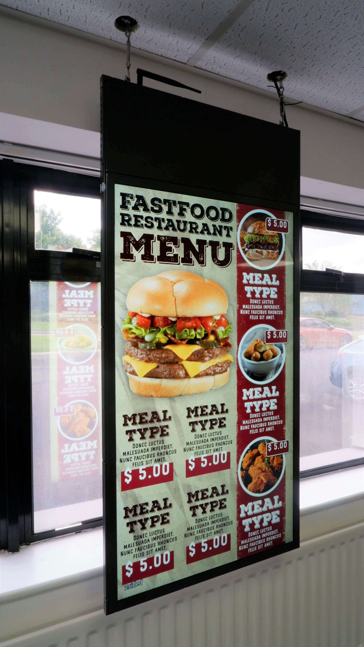 Double-sided hanging window display with fast food menu displayed