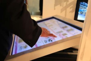Person interacting with interactive touchscreen map