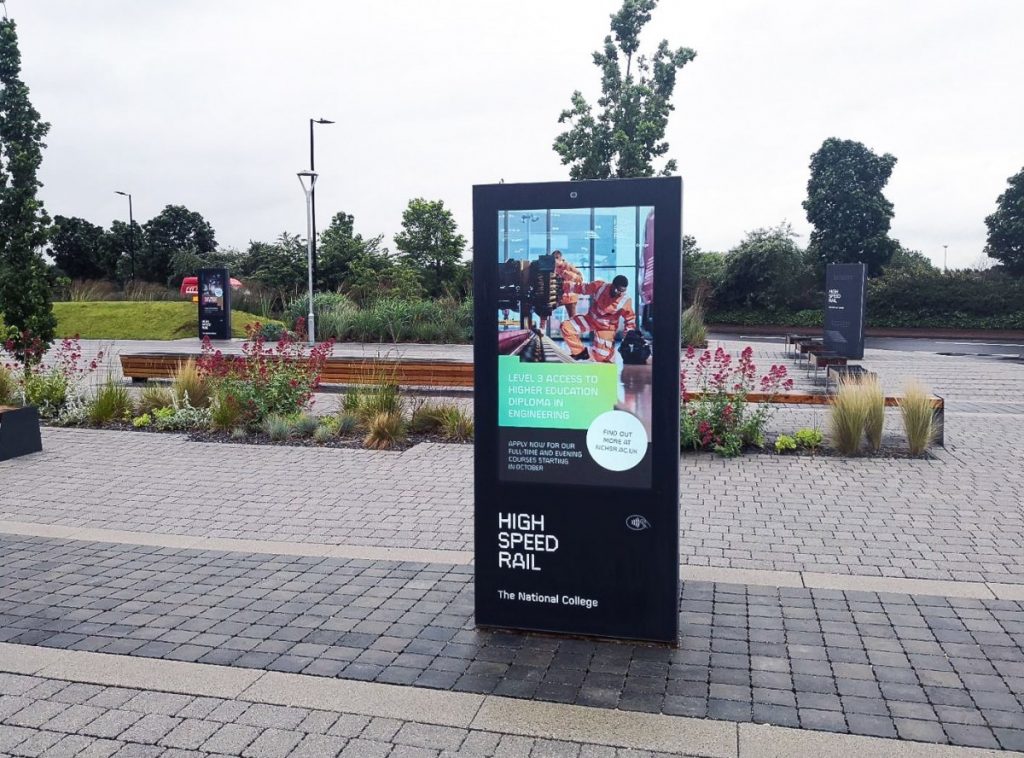 Outdoor digital signage kiosk placed on a path
