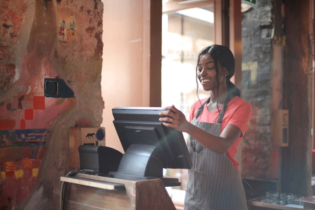 restaurant staff working with self-service kiosk