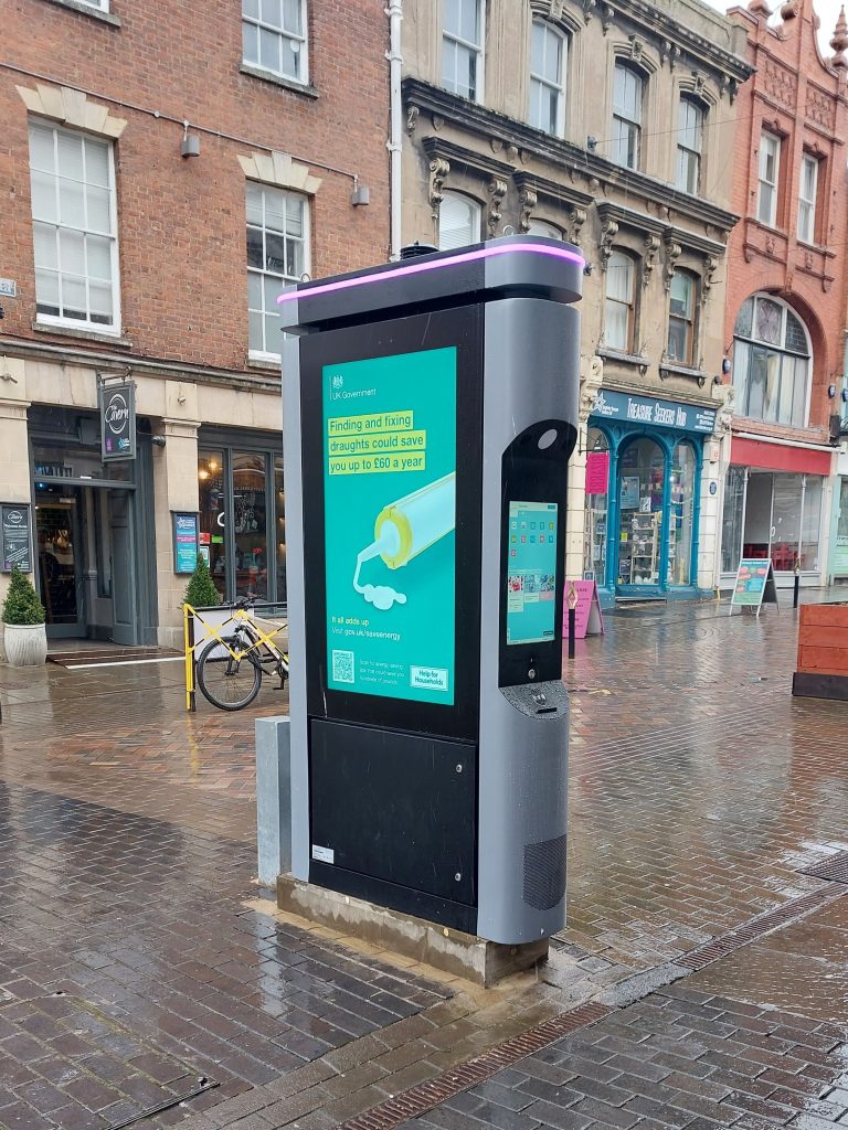 LamasaTech smart city kiosk showing advertisements in town centre in England